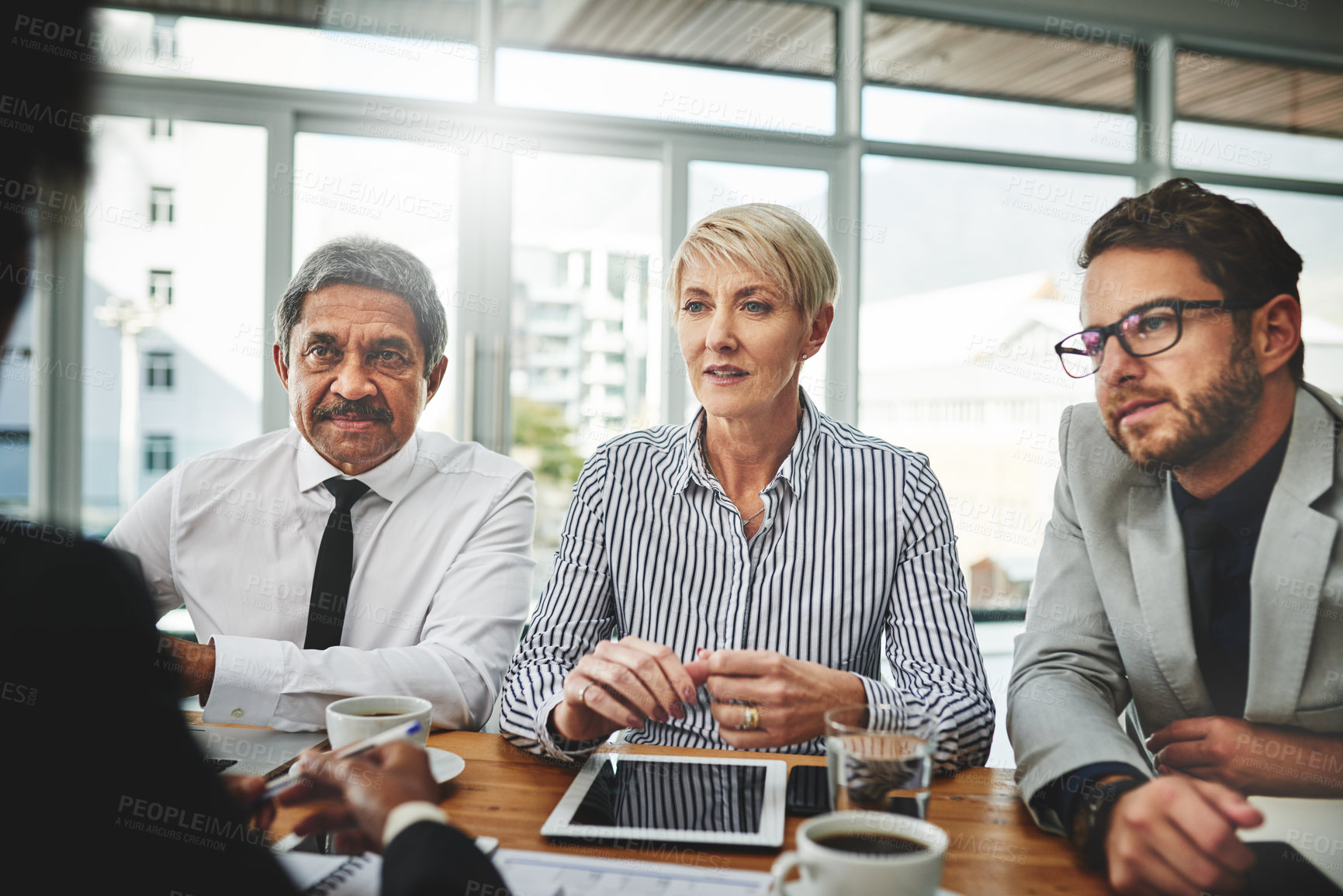 Buy stock photo Shot of a group of businesspeople having a meeting in an office