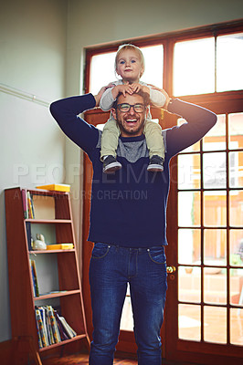 Buy stock photo Portrait of a father carrying his little son on his shoulders at home