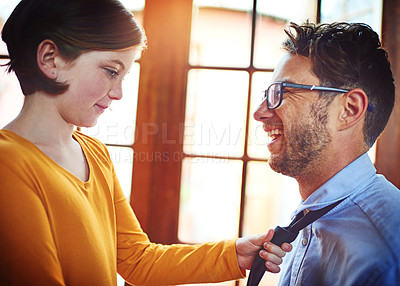 Buy stock photo Shot of a little girl adjusting her father's tie at home