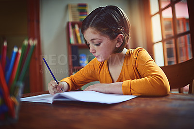Buy stock photo Shot of a little girl doing homework inside