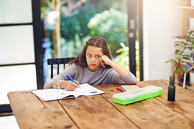 Buy stock photo Cropped shot of a young girl doing homework inside