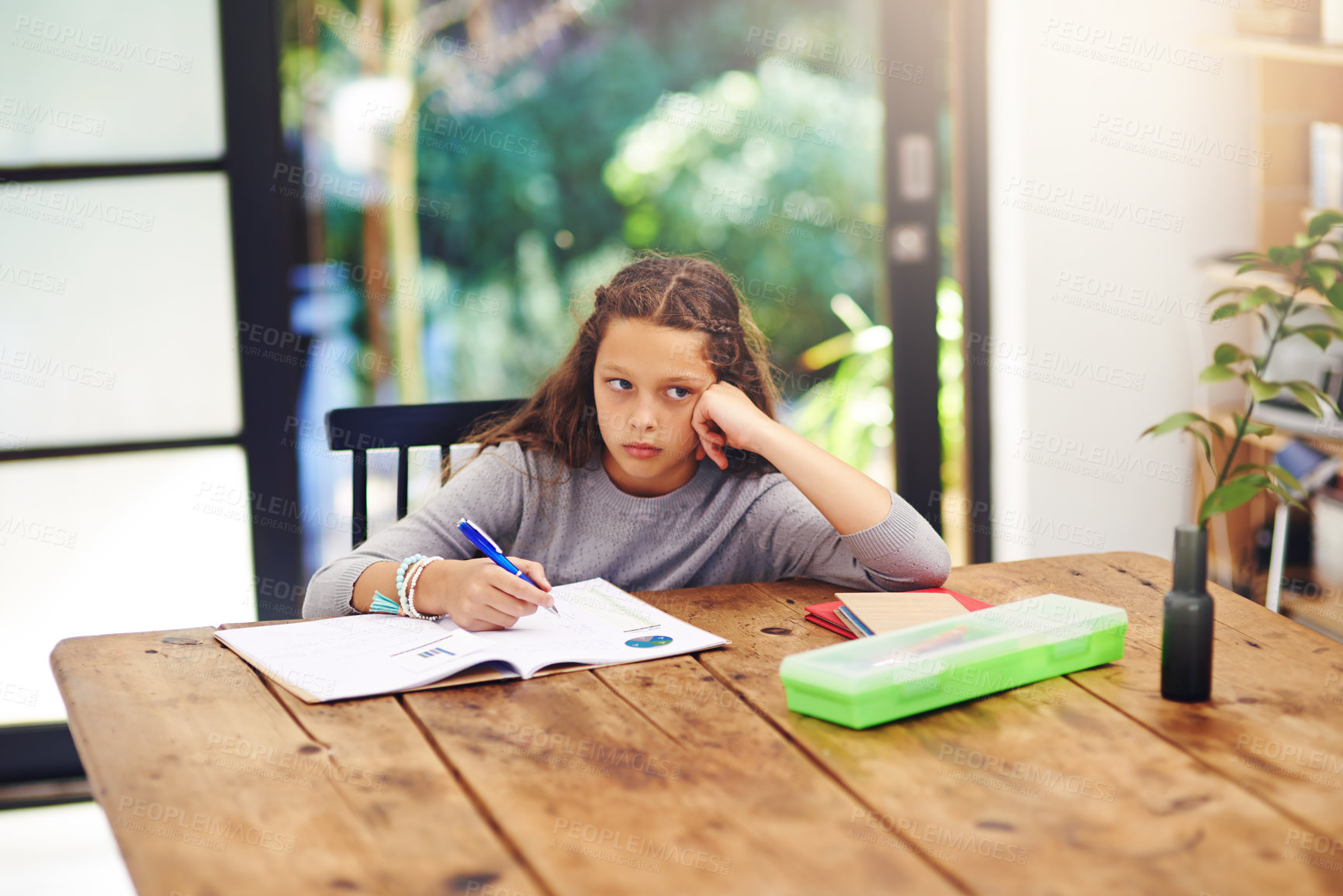 Buy stock photo Cropped shot of a young girl doing homework inside