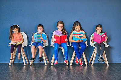 Buy stock photo Children, studying and row with books in studio for knowledge, development and learning for test. Chair, students and kids reading with paper for school education, scholarship and academic growth