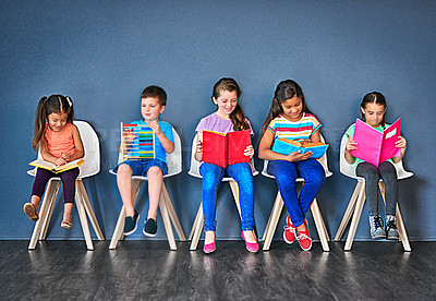 Buy stock photo Children, learning and row with books in studio for knowledge, development and studying for test. Chair, kids and students reading with paper for school education, scholarship and academic growth