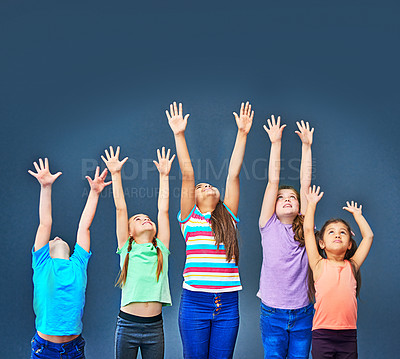 Buy stock photo Friends, children and group with hands up for stretching, fitness and exercise activity on blue background. Diversity, kids and together in celebration of education, learning or scholarship on mockup