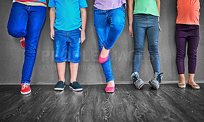 Buy stock photo Fashion, row and legs of children on wall background for trendy outfit, causal clothes and style. Diversity, youth and shoes of boys and girls in studio for back to school, education and learning