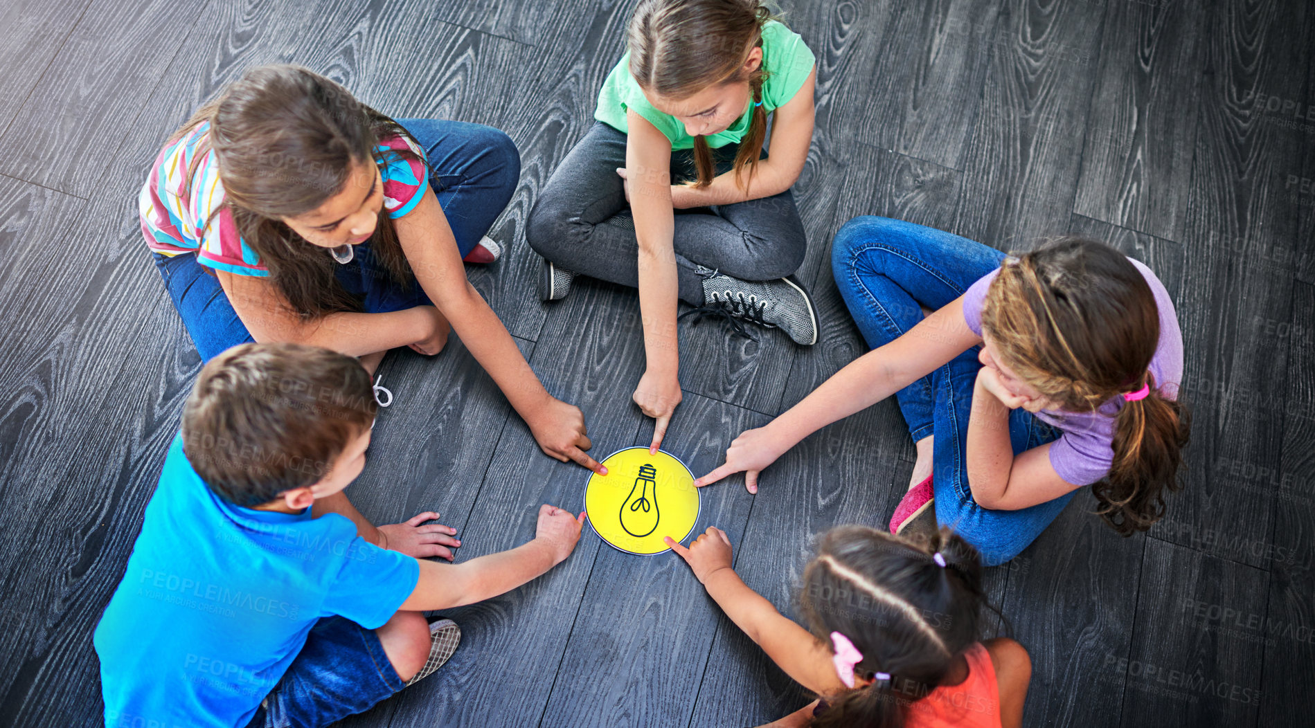 Buy stock photo Children, pointing and playing a game on floor with lightbulb, decision making and learning. Diversity circle, people and problem solving with educational activity, solution and knowledge on top view