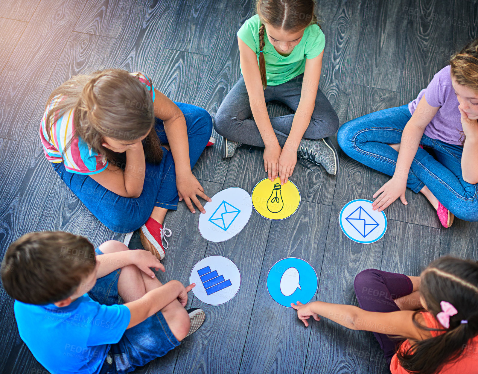 Buy stock photo Children, students and playing game on floor with communication icons, decision making and learning. Diversity, people and problem solving with educational activity, solution or knowledge on top view