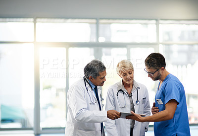 Buy stock photo Team or group of doctors, nurses and medical professional talking, meeting and discussing healthcare in a hospital. Health practitioners in labcoats looking at records on a tablet in a clinic