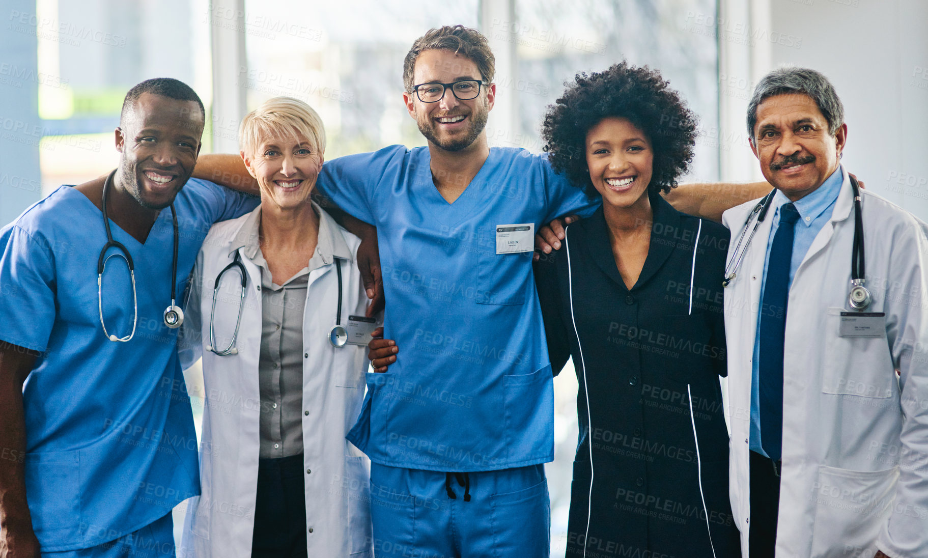 Buy stock photo Portrait of a diverse team of doctors standing together in a hospital