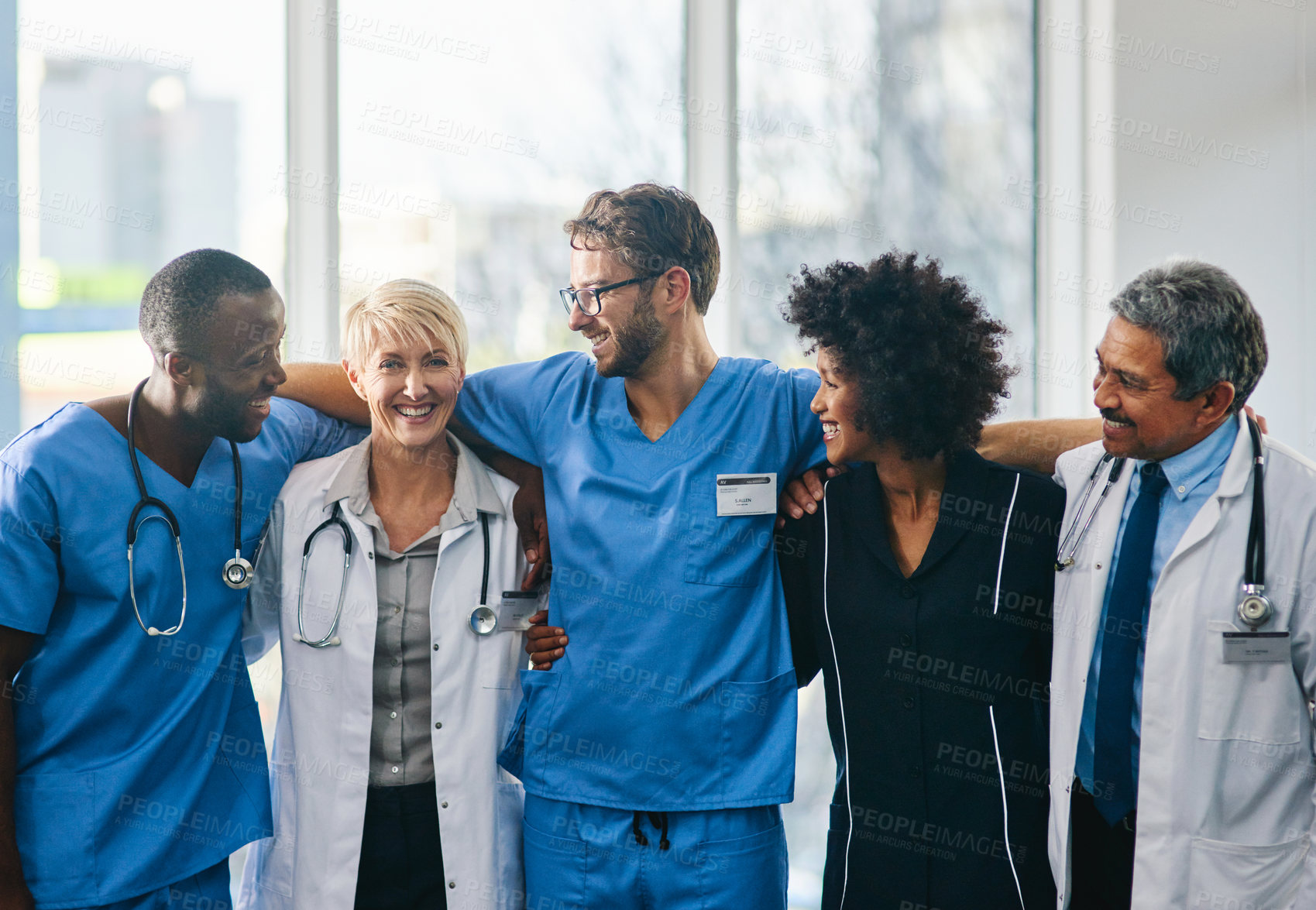 Buy stock photo Portrait of a diverse team of doctors standing together in a hospital