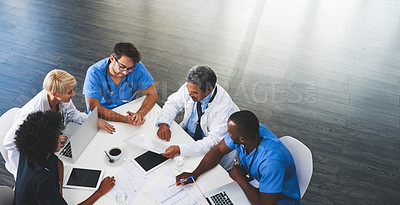 Buy stock photo Doctor, nurse and healthcare professional team or group sitting in the boardroom, talking about medicine and discussing treatment during a meeting. Planning and brainstorming a health cure from above