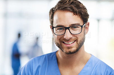 Buy stock photo Portrait of a happy professional young doctor working as a surgeon in a hospital. Confident man in the medical healthcare workspace. Expert man in health smiling and ready to help or aid patients.