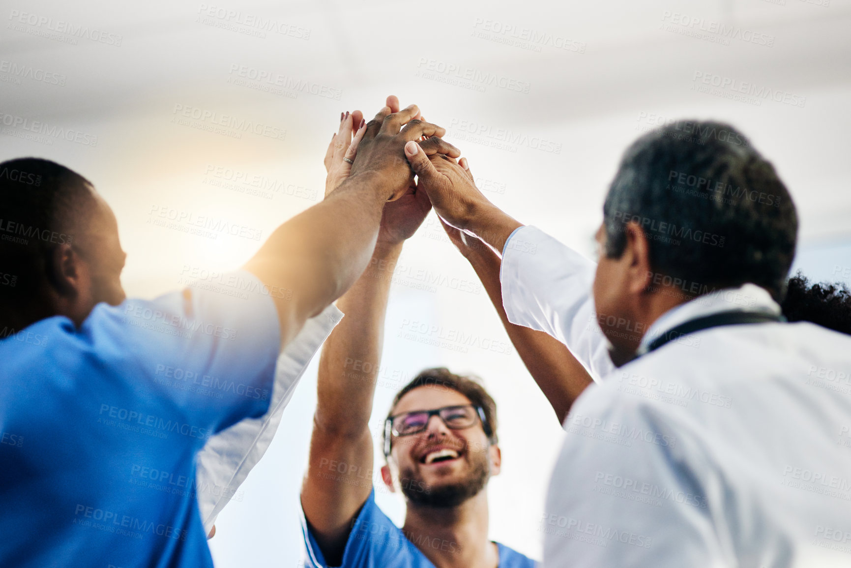 Buy stock photo Happy doctors, medical professionals and team giving high five in celebration of success, wining and achievement at a hospital. Group of health experts showing support, teamwork and excitement