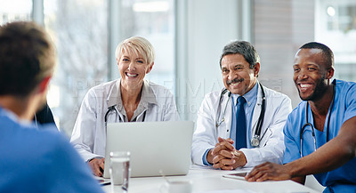 Buy stock photo Doctors, medical professionals and healthcare workers with laptop talking, meeting or planning medicine treatment in hospital. Diverse group of happy frontline colleagues researching or brainstorming