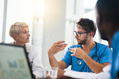 Buy stock photo Doctor, healthcare professional and medical worker in a boardroom meeting with colleagues and coworkers in the hospital. Male practitioner talking, discussing and planning a treatment with his team