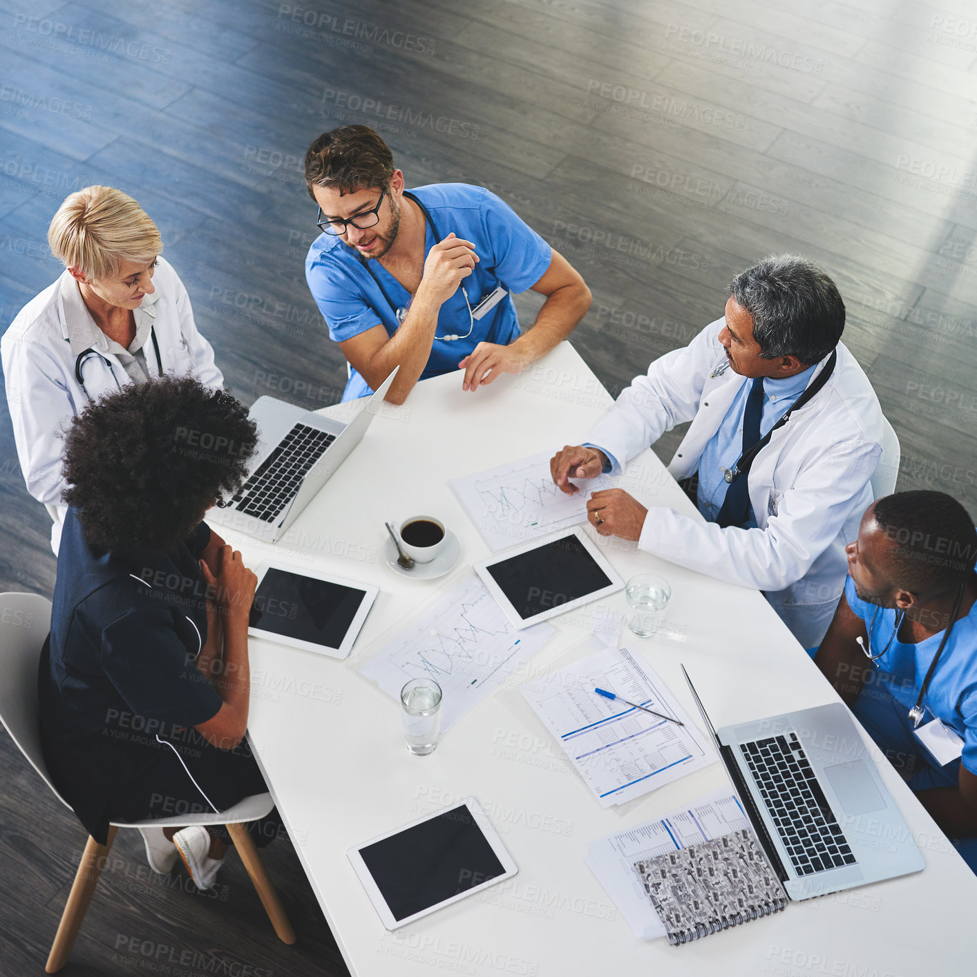 Buy stock photo High angle shot of a team of doctors having a meeting in a hospital