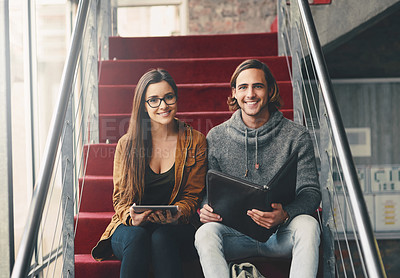 Buy stock photo Cropped portrait of two young university students studying while sitting on a staircase on campus