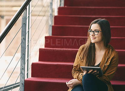 Buy stock photo Cropped shot of an attractive young university student studying while sitting on a staircase on campus