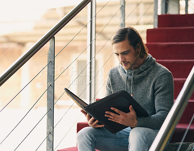 Buy stock photo Man, student and relax on steps with folder for educational documents, coursework review and study notes. Male learner, academic file and reading on stairs in university for lesson and class schedule