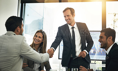 Buy stock photo Shot of businesspeople shaking hands in a boardroom meeting