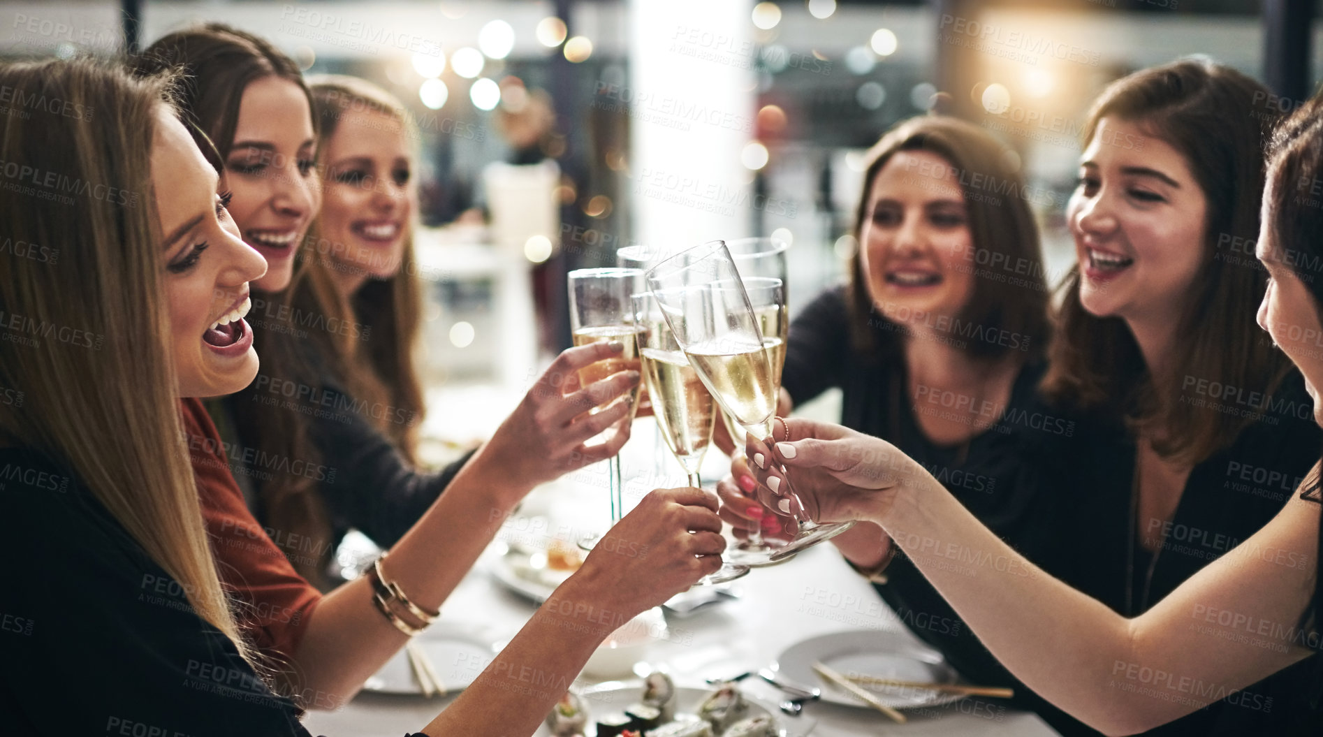 Buy stock photo Group, women and champagne for toast in restaurant for dinner party, celebration and sushi with lens flare. Friends, cheers and happy by table with alcohol glass, girls night and seafood for congrats