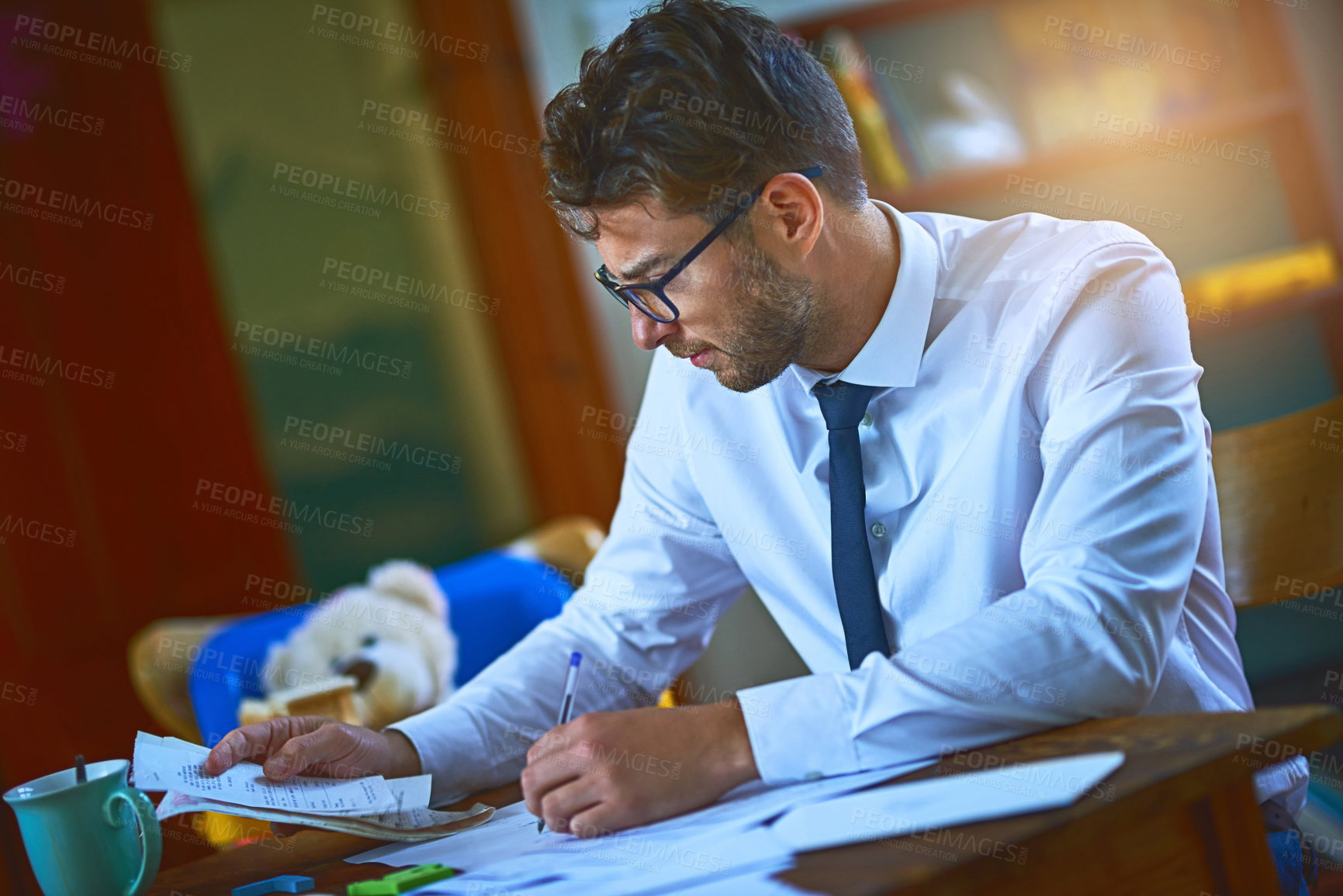 Buy stock photo Cropped shot of a single father paying his bills at home