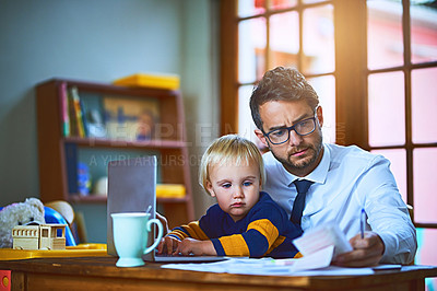 Buy stock photo Shot of a single father going through paperwork at home