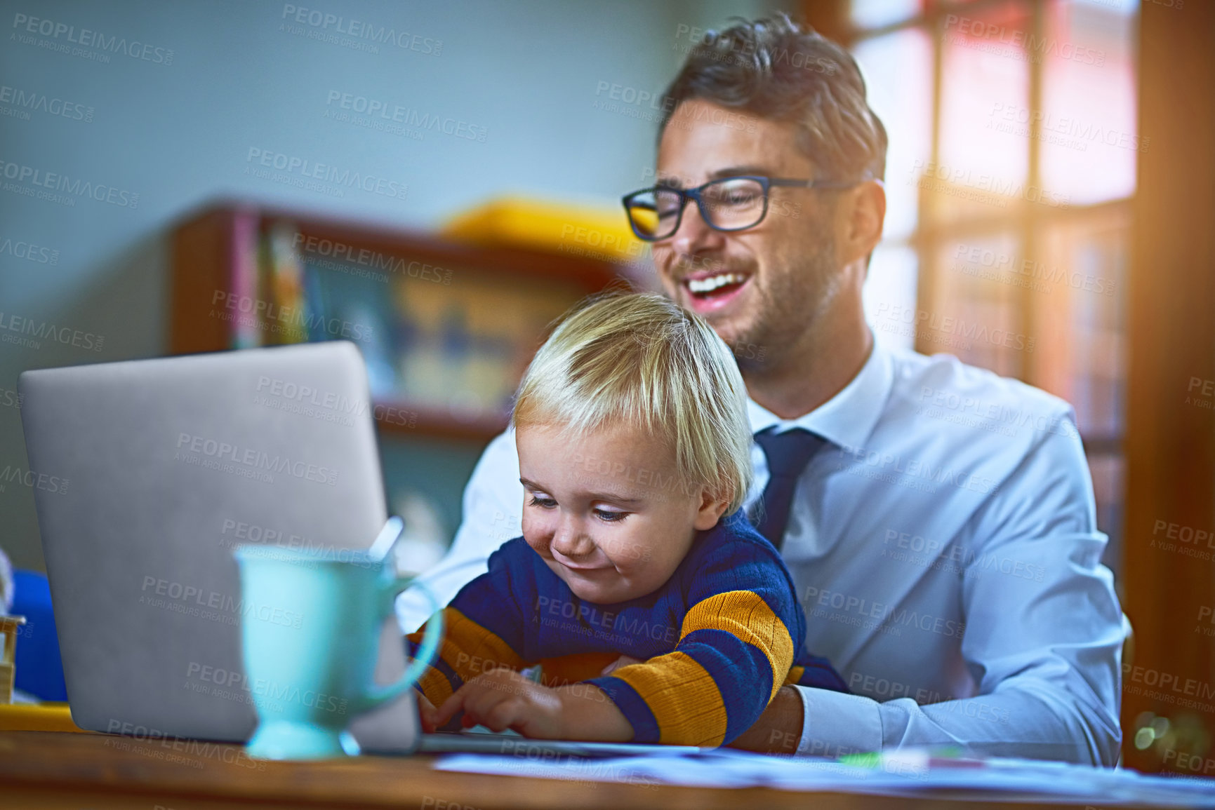 Buy stock photo Happy man, boy and laptop as single parent for love or support in family home as remote worker. Male person, child and tech for games, bonding and play in lounge for affection, growth and development