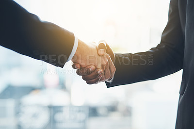 Buy stock photo Closeup shot of two businessmen shaking hands in an office