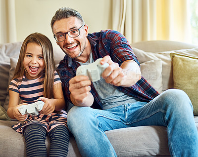 Buy stock photo Cropped shot of a handsome mature man and his daughter playing video games