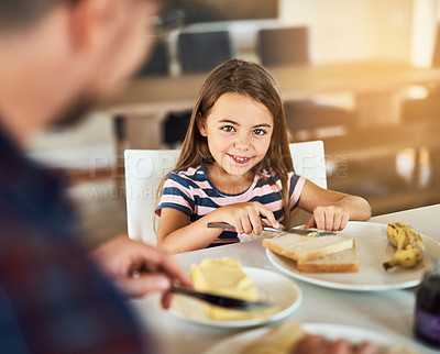 Buy stock photo Breakfast, portrait and daughter with dad, smile or morning in kitchen, toast or dining table in home. Healthy, father or food of family, child and man in house, eating and bonding with love together