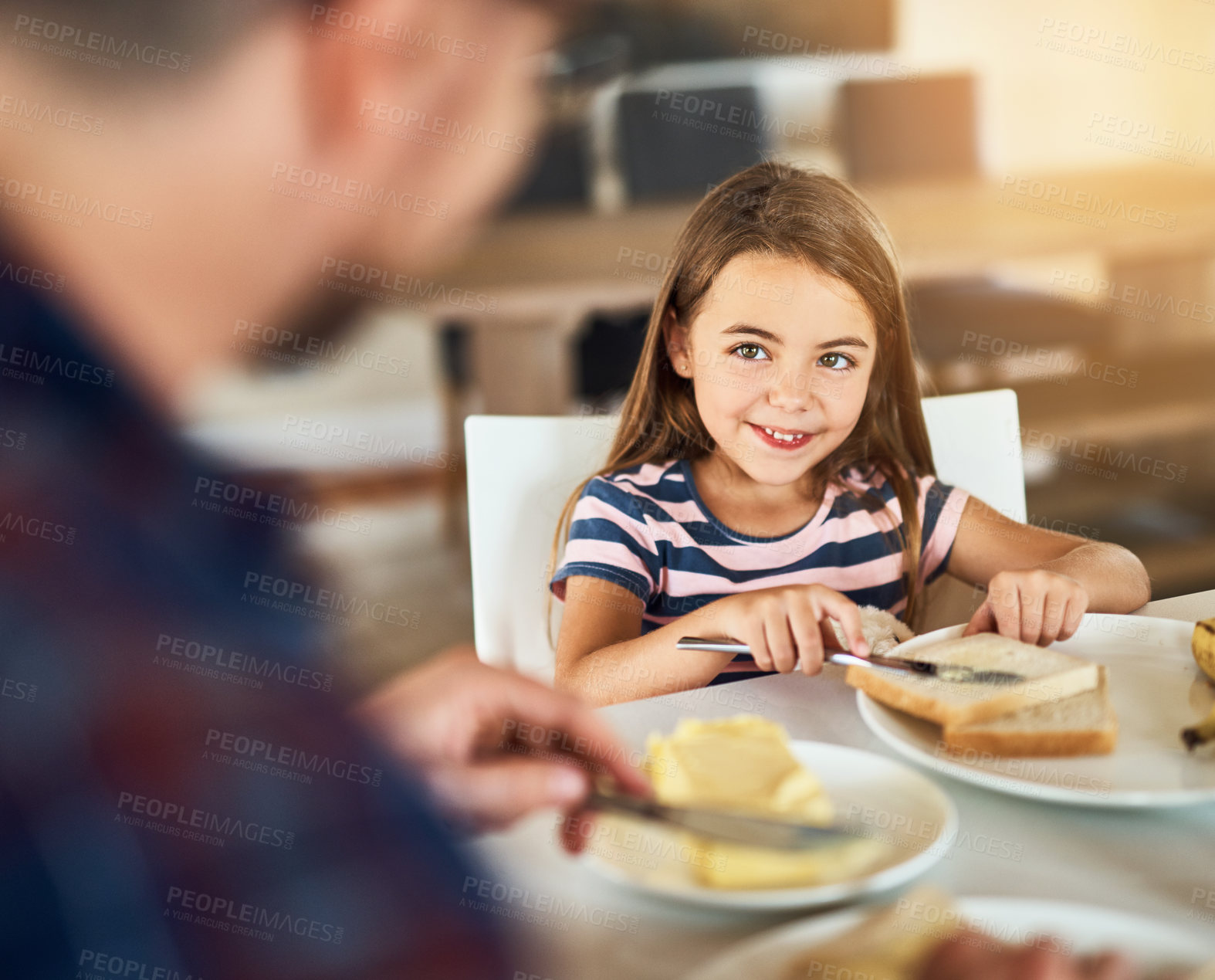 Buy stock photo Cropped shot of an adorable little girl having breakfast with her father in the kitchen