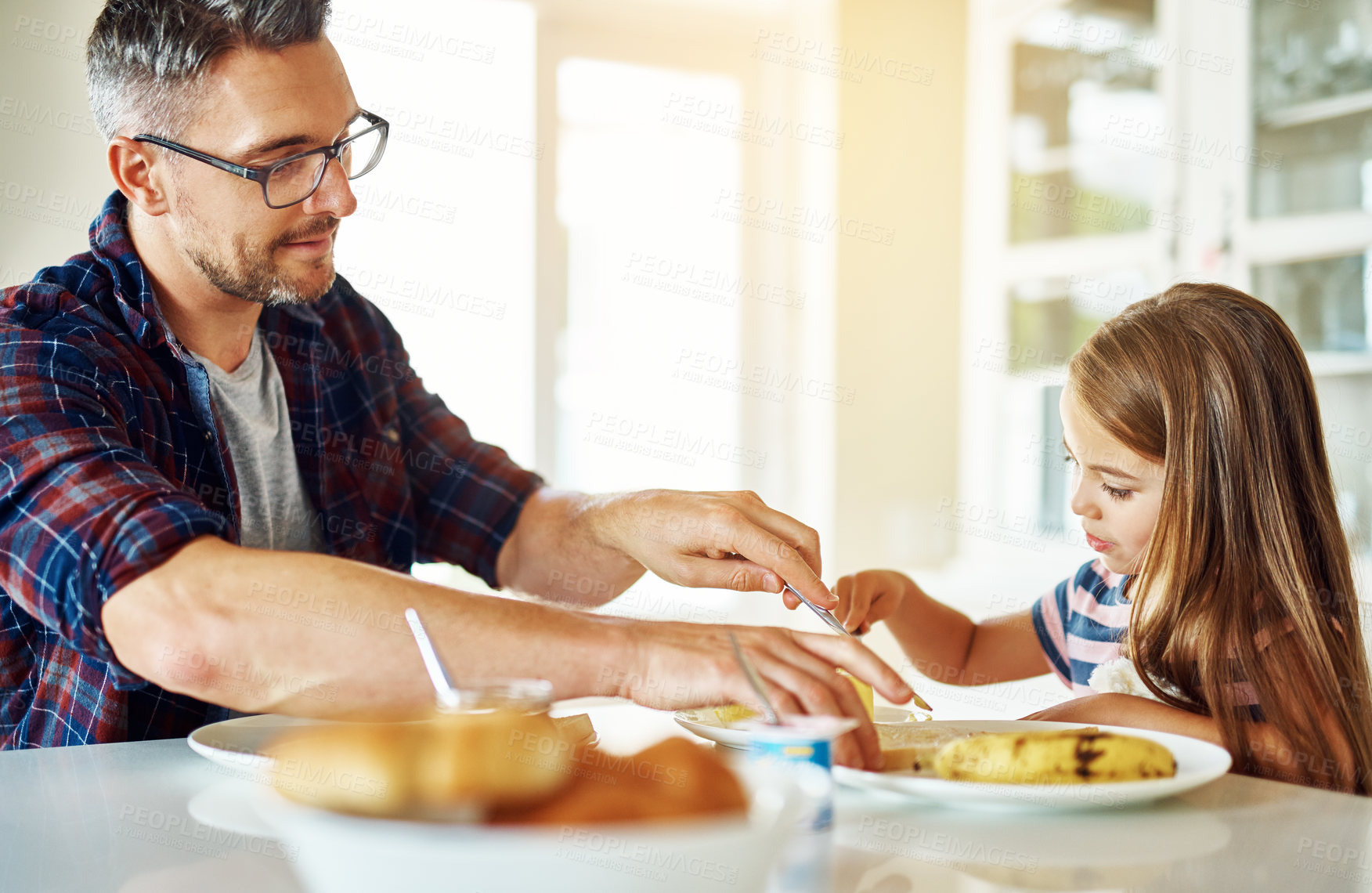 Buy stock photo Breakfast, bread and daughter with dad, eating or morning in kitchen, butter and dining in home. Healthy, father and food of family, child and man in house, table and bonding with love together
