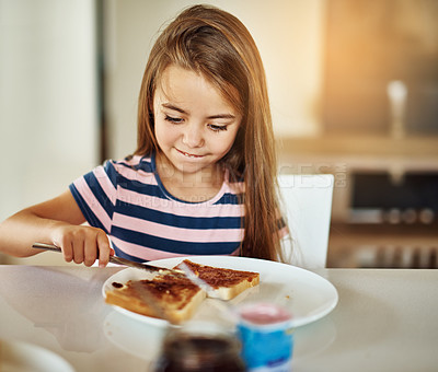 Buy stock photo Cropped shot of an adorable little girl having breakfast in the kitchen