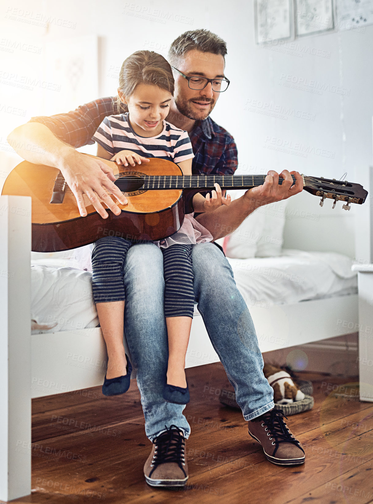 Buy stock photo Full length shot of a handsome mature man teaching his young daughter how to play the guitar