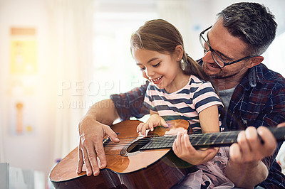 Buy stock photo Learning, guitar and girl, man with smile for music or bonding or love or play at house. Happiness, teaching and kid, father with acoustic or musical instrument for fun or education at family home.