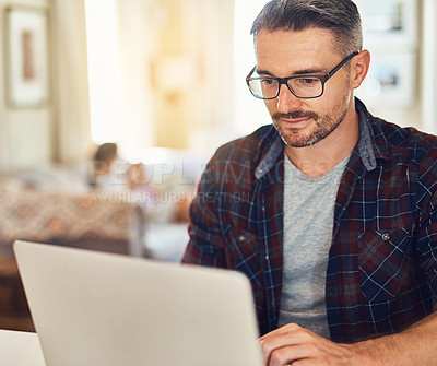 Buy stock photo Businessman, glasses and typing with laptop for email, communication or connectivity at home. Man, freelancer or employee with computer for remote work, online connection or business network at house