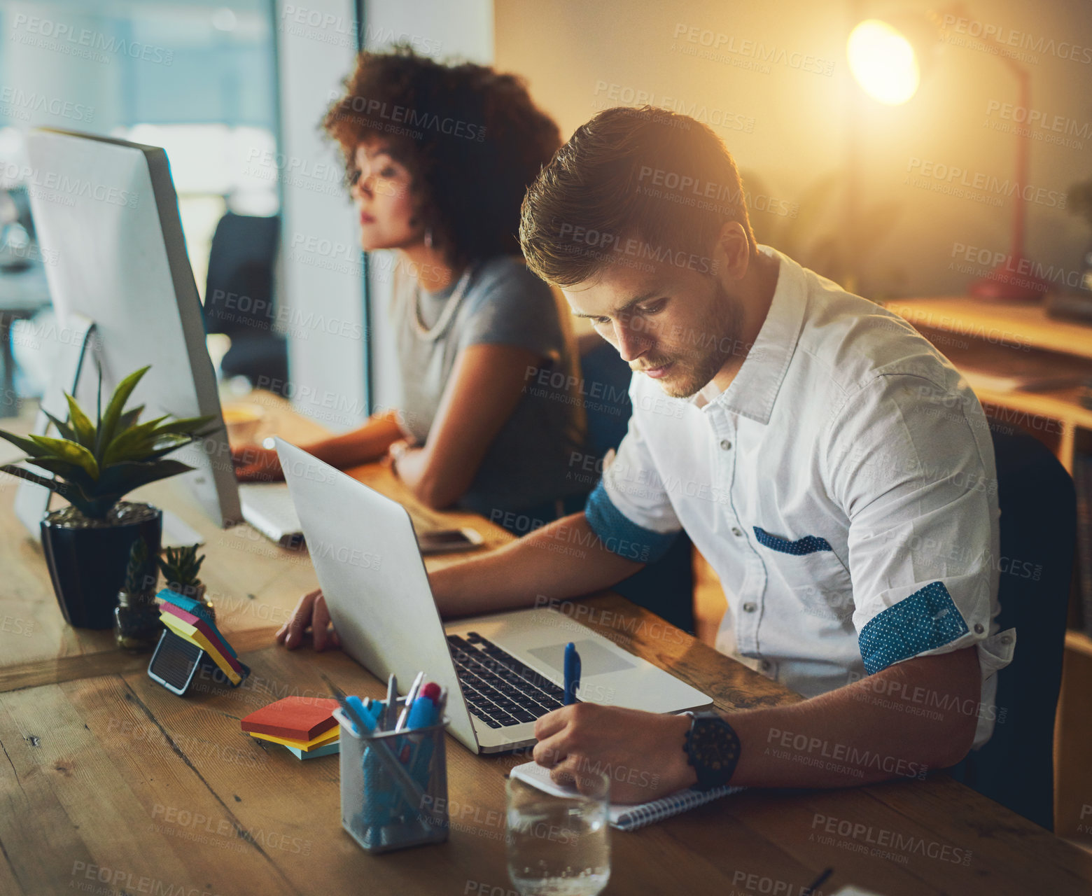 Buy stock photo Partnership, laptop and man with notes in night, office and working late for deadline of project. Business, colleagues and teamwork for web design, creative and dark in workspace, online and serious