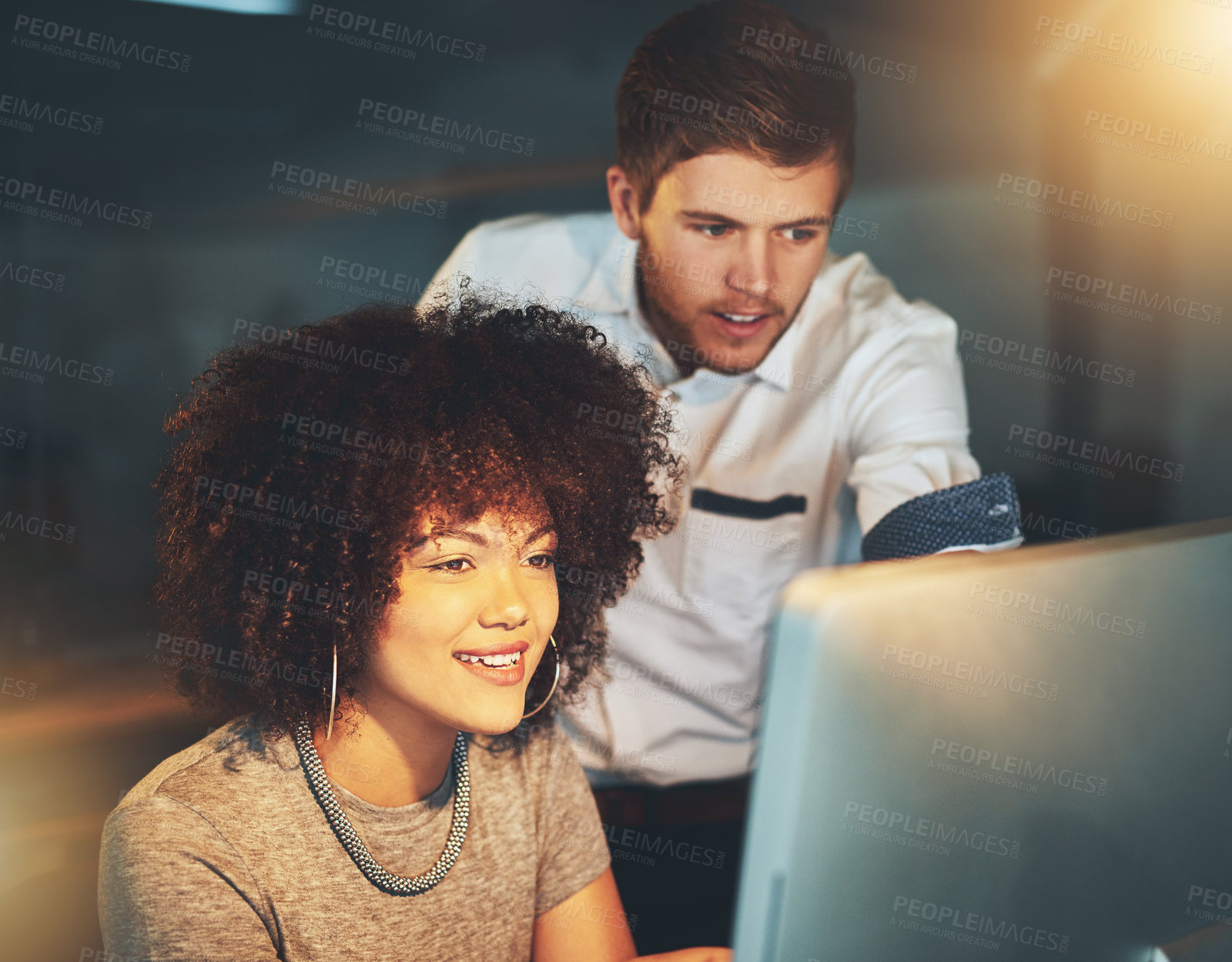 Buy stock photo Cropped shot of young employees working late into the evening