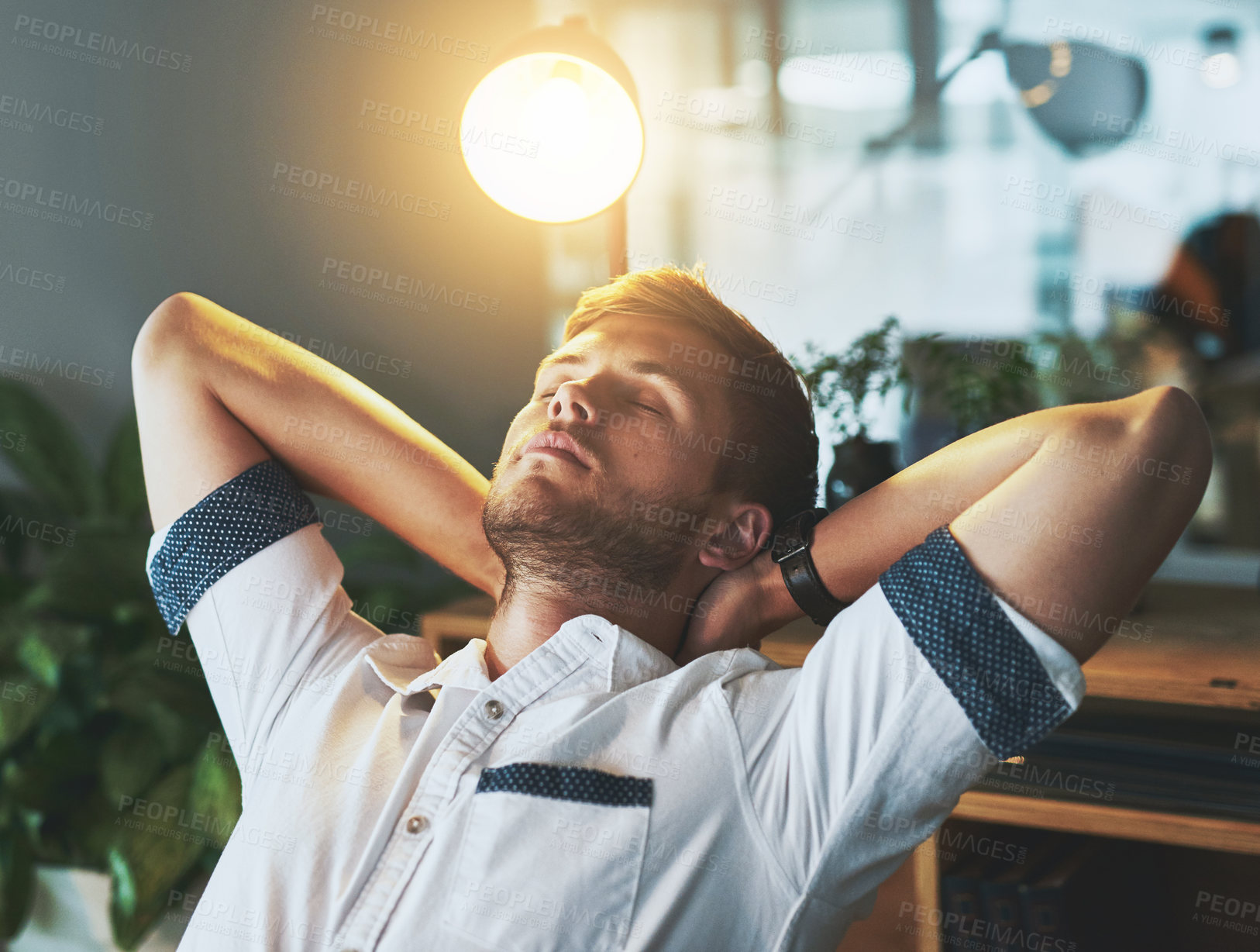 Buy stock photo Night, relax and business with man, fatigue and sleeping with finished project, overworked and burnout. Hands behind head, employee and graphic designer in modern office, exhausted and tired