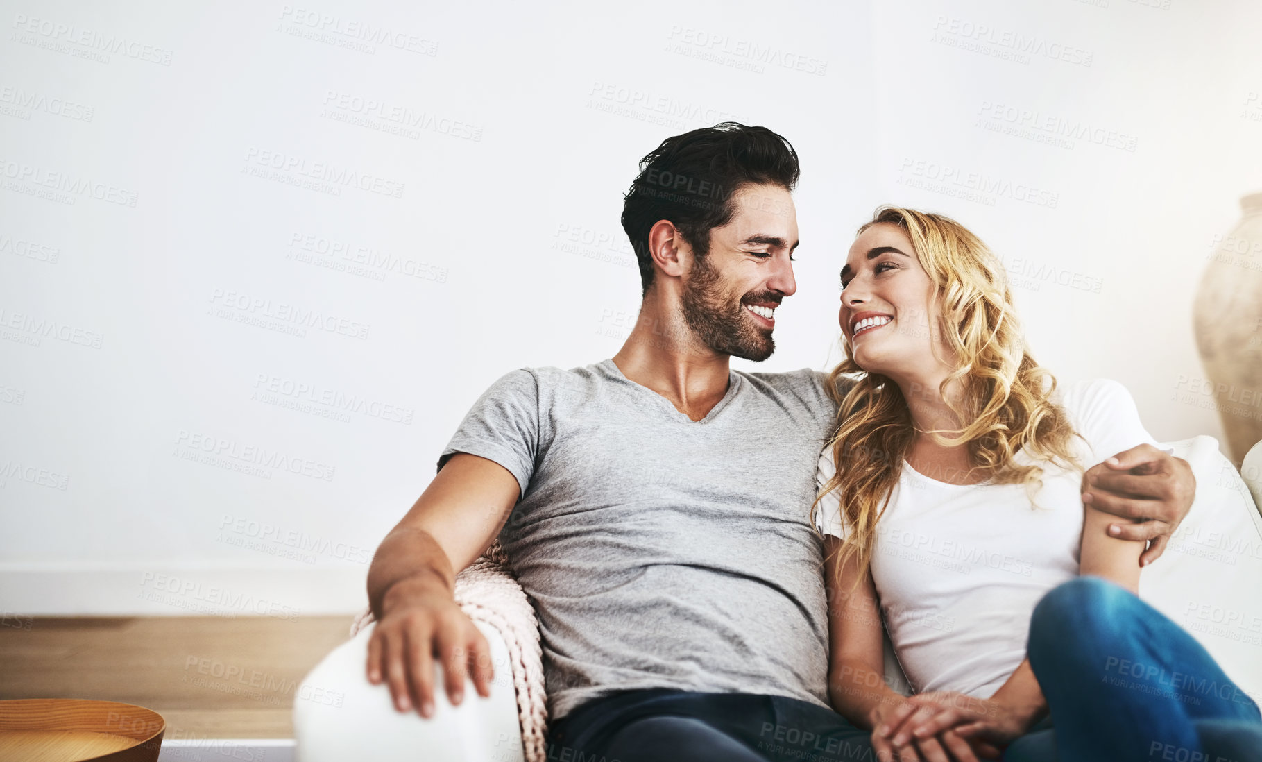 Buy stock photo Smile, relax or happy couple hugging on house sofa bonding or smiling with trust or loyalty together. Smile, lovers or woman enjoys quality time with a romantic man on couch on weekend break at home