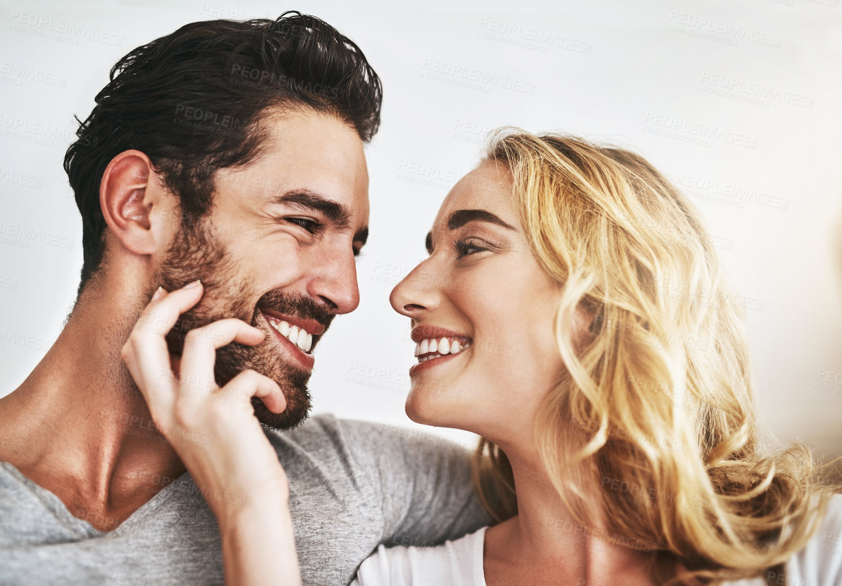 Buy stock photo Smile, faces or happy couple in house bonding or smiling with trust, romance or loyalty together. Eye contact, affection or woman loves quality time with a romantic man on holiday weekend at home