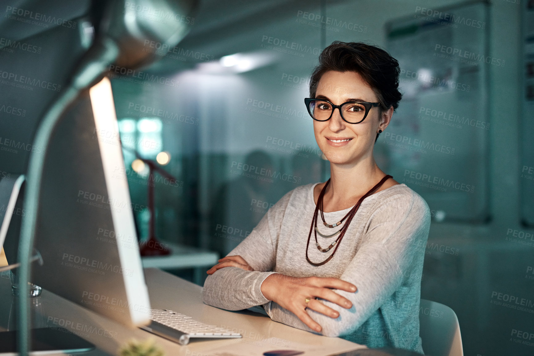 Buy stock photo Shot of a young businesswoman working late at the office