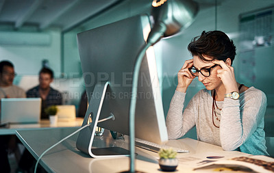 Buy stock photo Shot of a young businesswoman experiencing a headache in the office