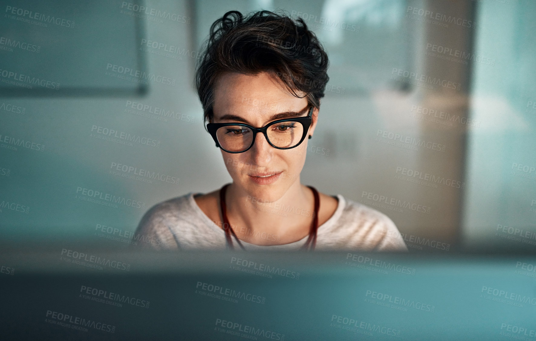 Buy stock photo Shot of a young businesswoman working late at the office