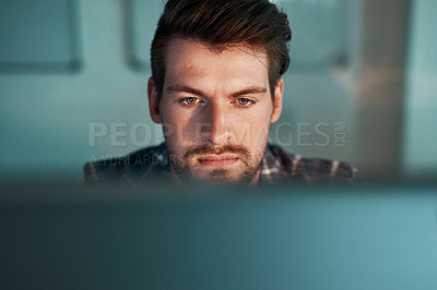Buy stock photo Shot of young businessman working late at the office