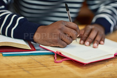 Buy stock photo Closeup shot of an unidentifiable university student writing in a book at campus