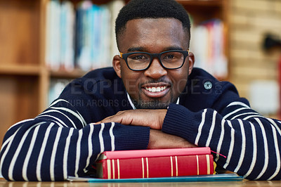 Buy stock photo Portrait of a university student sitting in the library at campus