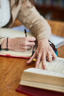 Buy stock photo Hands, person and books for writing at university in library for education, development and ready at academy. Student, reading and pen for notes for test, exam and research in study hall at college